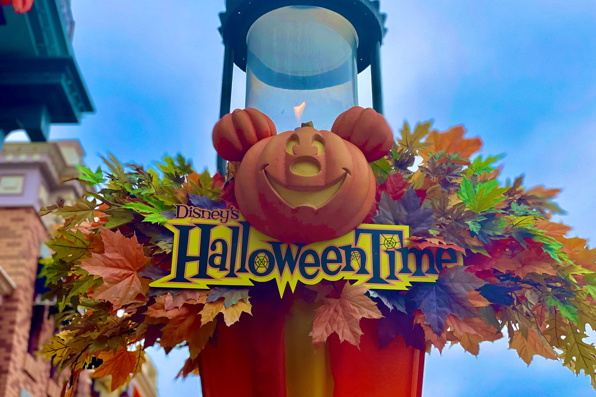 Halloween Time decorations with a Mickey pumpkin at a Disney park entrance
